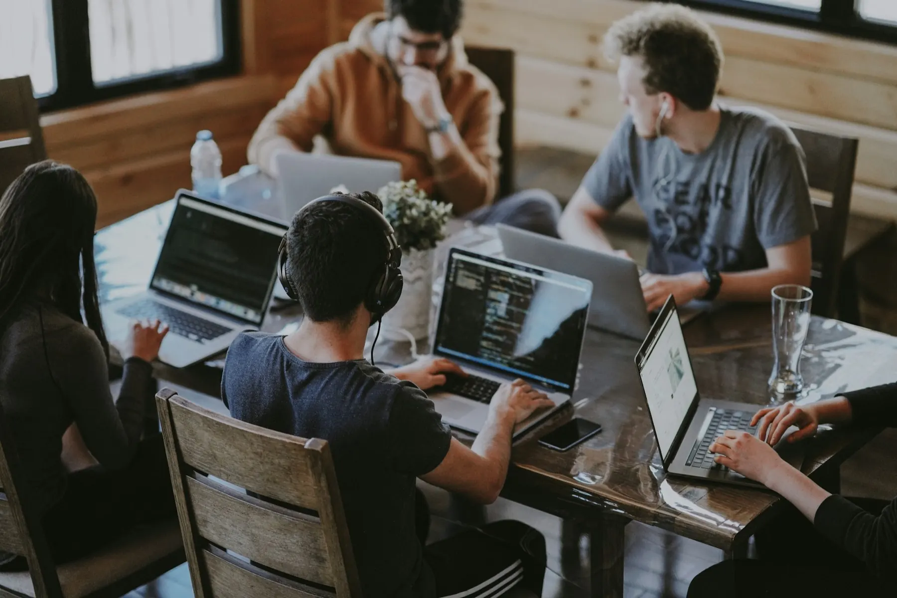 A team collaborating around laptops while building software