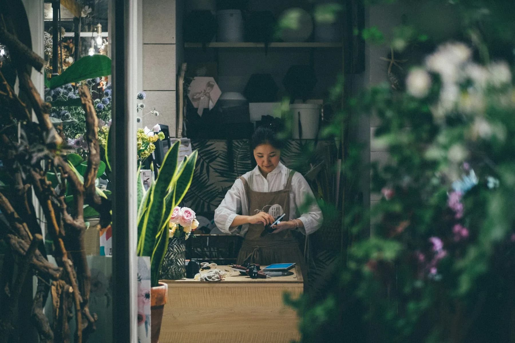 An independent flower shop owner at work