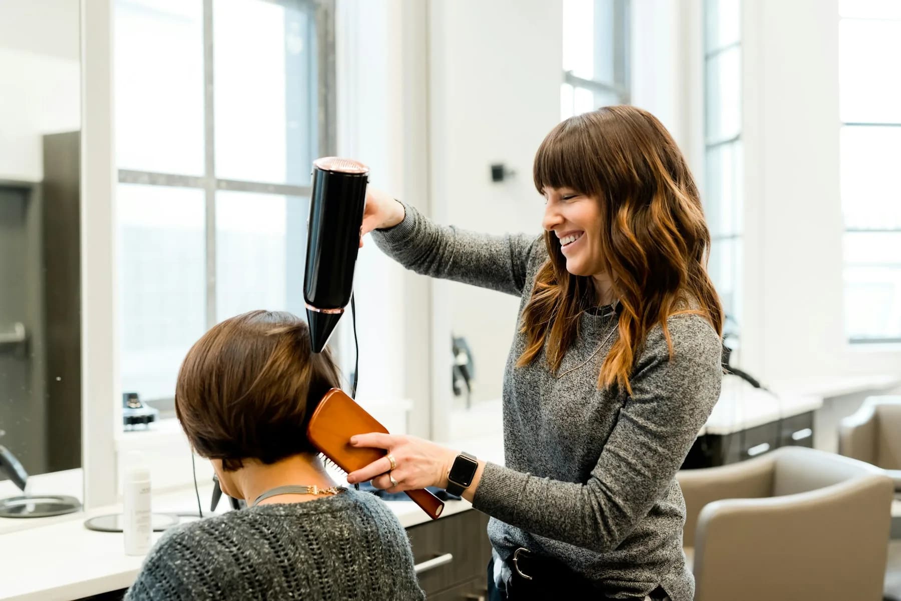 An independent salon professional serving a client
