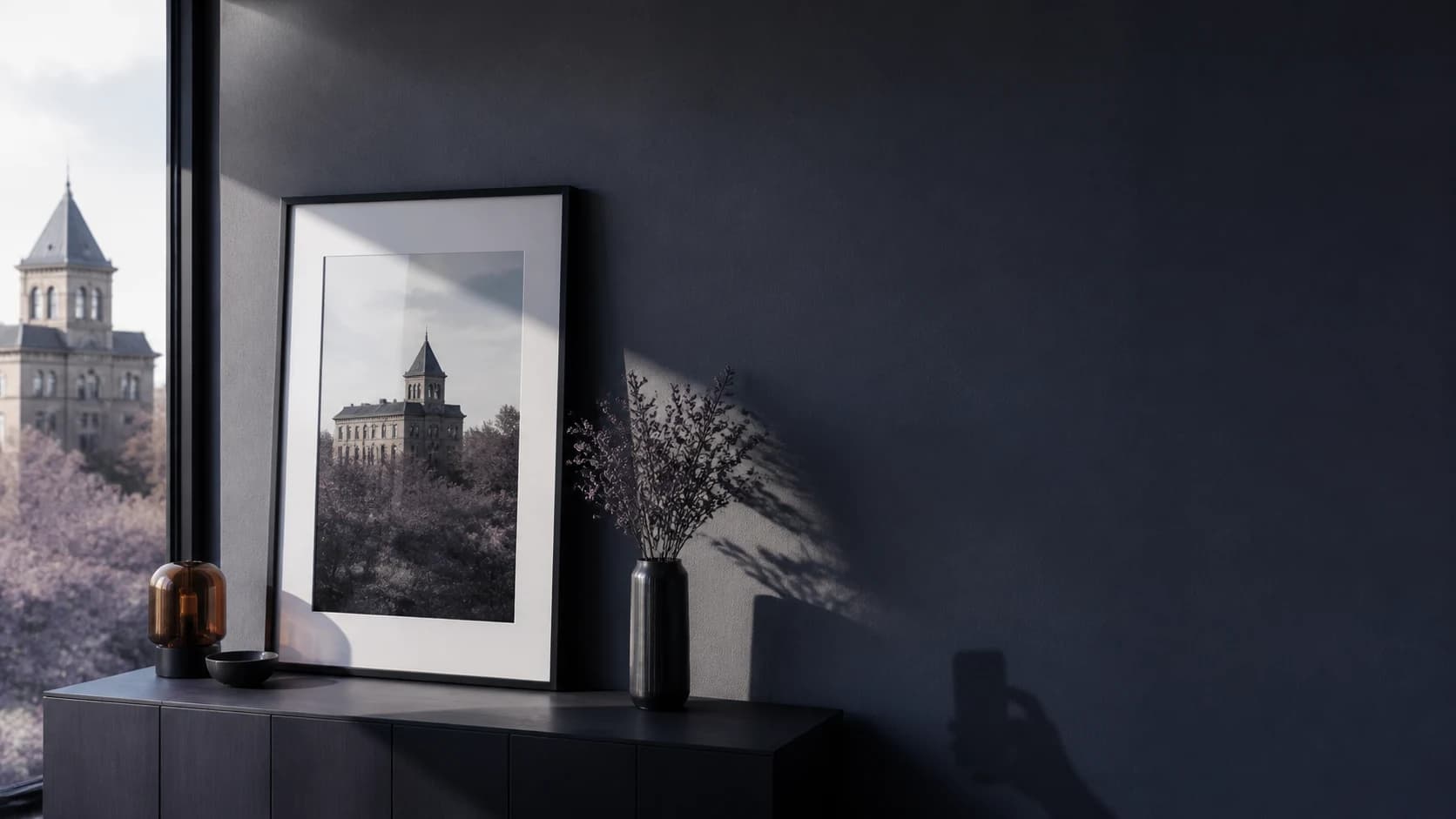 A framed reference photograph beside a window, evoking a return to the same composition
